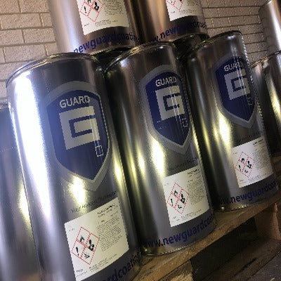 Tins of solvents with Guard logo, on a shelf