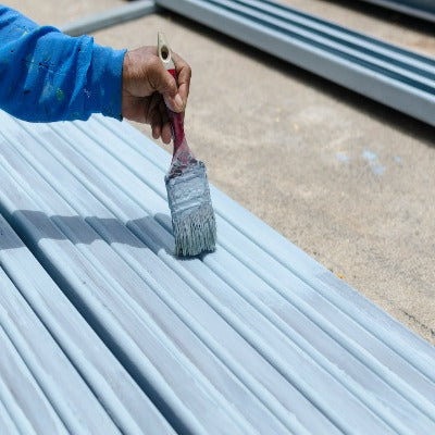 Hand painting steel with a paintbrush