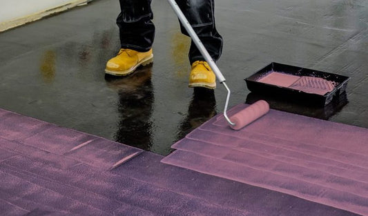Applying pink floor primer with a roller