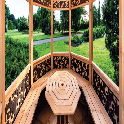 Inside a wooden gazebo with octagonal wooden table in the centre, and view of green landscaped gardens